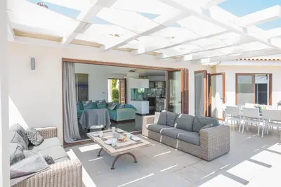 a living room with couches and a table at Oscar Domain Villa in Protaras