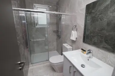a bathroom with a shower and a toilet and a sink at Fig Tree Bay Residences 1 Lantiana Villa in Protaras