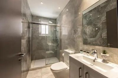 a bathroom with a shower and a toilet and a sink at Fig Tree Bay Residences 1 Lantiana Villa in Protaras