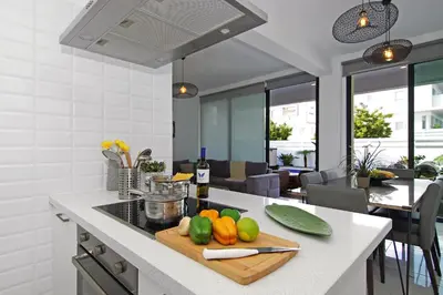 a kitchen with a cutting board with vegetables on a counter at Villa Maritime in Protaras