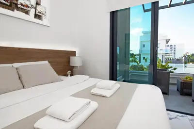 a bedroom with a white bed with two towels on it at Villa Maritime in Protaras