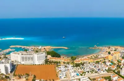 an aerial view of a beach with buildings and the ocean at Villa Maritime in Protaras