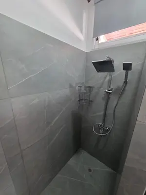 a bathroom with a shower with a shower head at Town centre suites in Larnaka