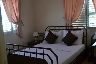a bedroom with a bed with white sheets and pillows at 13 Sandy Beach Mackenzie in Larnaka