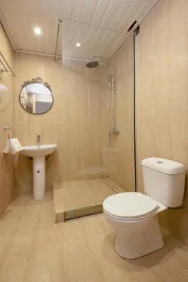 a bathroom with a toilet and a shower and a sink at Cottage Houses in Pendakomo