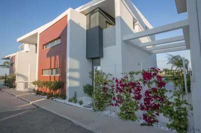 a house with flowers on the side of it at White Pearl Villa 7 in Protaras