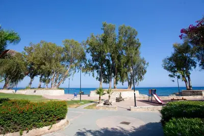 a park with a playground and the ocean in the background at Galatex Beach Living by TrulyCyprus in Limassol