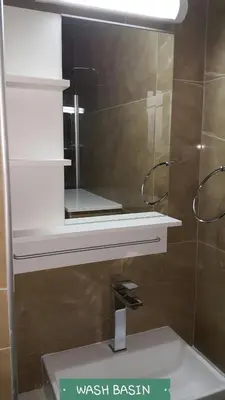 a mirror above a sink in a bathroom at CHRIS'S KYKLADES HOLIDAY APARTMENT in Paralimni