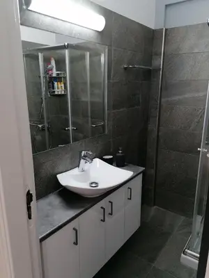 a bathroom with a sink and a shower at Must Stay - Finikoudes Seaview in Larnaka