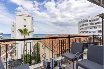 a balcony with chairs and a view of the ocean at Must Stay - Finikoudes Seaview in Larnaka