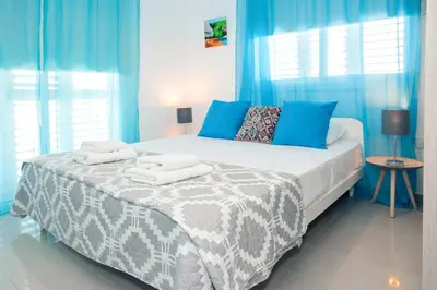 a blue bedroom with a bed with towels on it at Nissini Nero, 3 bedroom villa with private pool, 5 min to the beach in Ayia Napa