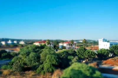 a group of houses on a hill with trees at Nissini Nero, 3 bedroom villa with private pool, 5 min to the beach in Ayia Napa