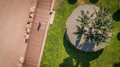 an overhead view of a walkway with palm trees at Infinity Blu - Designed for Adults by Louis Hotels in Protaras
