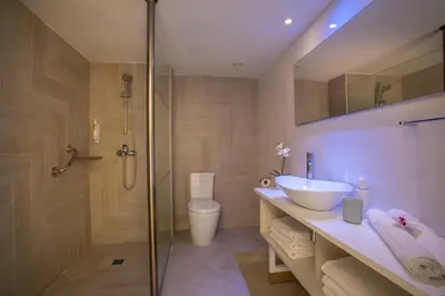 a bathroom with a shower and a sink and a toilet at Infinity Blu - Designed for Adults by Louis Hotels in Protaras