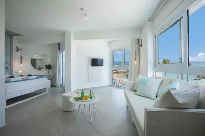 a living room with a white couch and a table at Infinity Blu - Designed for Adults by Louis Hotels in Protaras