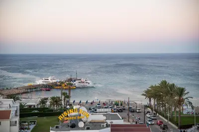 a cruise ship in the water next to a beach at Mandali Hotel in Protaras