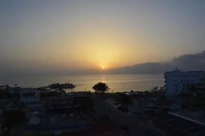 a sunset over the ocean with a city at Mandali Hotel in Protaras