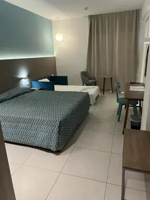 a hotel room with a bed and a table and chairs at Mandali Hotel in Protaras