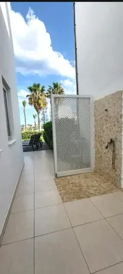 a gate in the side of a building with palm trees at Villa Sorelle in Protaras