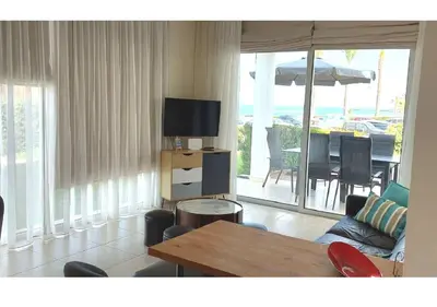 a living room with a couch and a table with a television at Villa Sorelle in Protaras