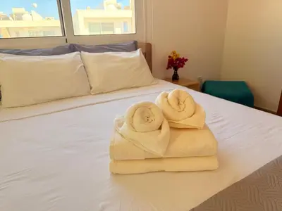 two towels sitting on top of a bed at Lovely holiday home,Kapparis,2 swimming pools,Wifi in Paralimni