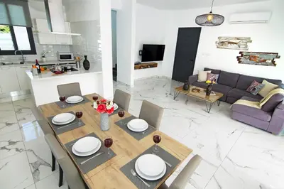 a living room with a table and a couch at Villa Martha in Protaras