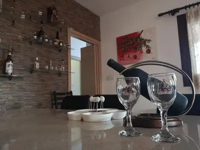 a table with two wine glasses on top of it at Kalamospito Holiday House in Kalokhorio