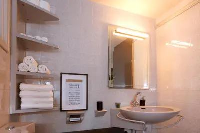a bathroom with a sink and a mirror at The Bridge-House Apartment in Nicosia