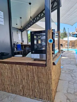 a restaurant counter with a blue object on it at Twins Apartments in Kato Pyrgos