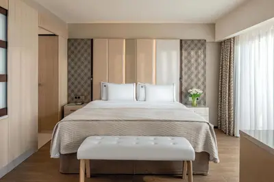 a bedroom with a large bed with a white bedspread at Four Seasons Hotel in Limassol