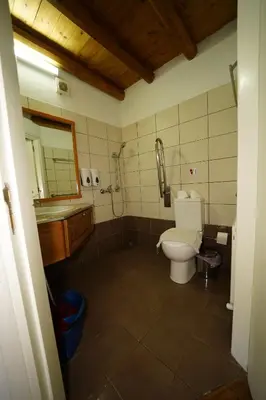 a bathroom with a toilet and a sink and a shower at Linos Inn in Kakopetria
