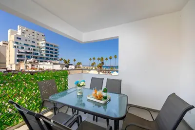 a table and chairs on a balcony with a view at AirBnSea City Centre Side Sea view Apartments in Larnaka