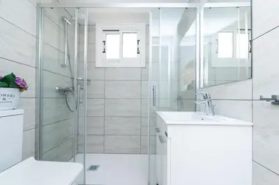 a bathroom with a shower and a toilet and a sink at Fig Tree Z Holiday Resort in Paralimni