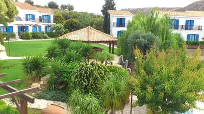 an aerial view of a garden in front of a building at Hylatio Tourist Village in Pissouri