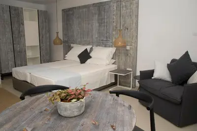 a bedroom with a bed and a table and a couch at Hylatio Tourist Village in Pissouri