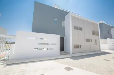 a large white building with a building at Villa Alana in Protaras
