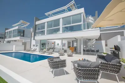 a villa with a swimming pool and a house at Villa Alana in Protaras