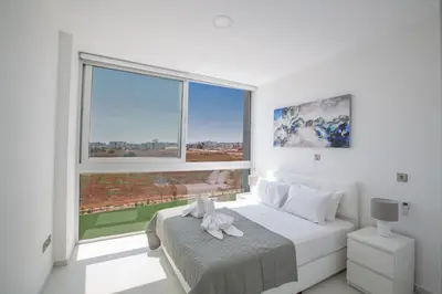 a bedroom with a bed with a large window at Villa Alana in Protaras