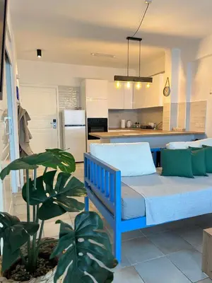 a bedroom with a blue bed in a kitchen at Krasas Beach in Larnaka