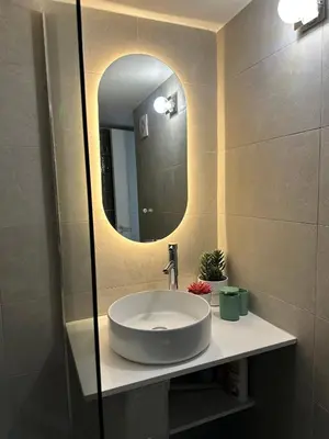 a bathroom with a sink and a mirror at Krasas Beach in Larnaka