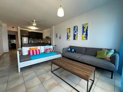 a living room with a couch and a coffee table at Krasas Beach in Larnaka