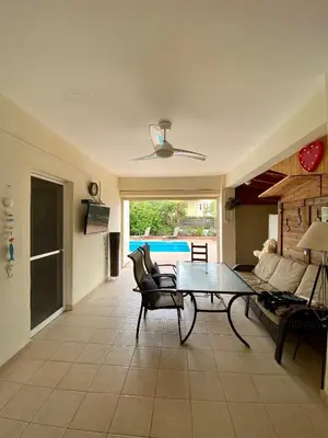 a living room with a table and a couch at Sea View Villa in Agia Thekla in Ayia Napa
