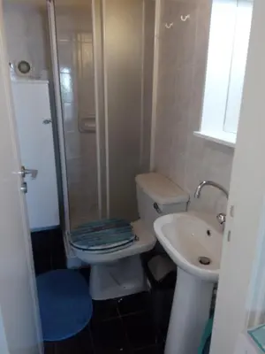 a small bathroom with a toilet and a sink at Lighthouse in Larnaka