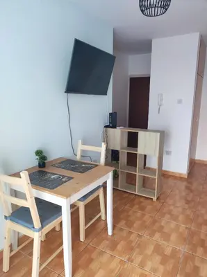 a dining room with a table and two chairs at Hawaii Royal Gardens 2 in Limassol
