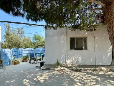 a white house with a window and a fence at Detached Cozy Studio in Paralimni