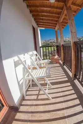 a deck with two white chairs on it at Lania Royal Oak House by TrulyCyprus in Lania