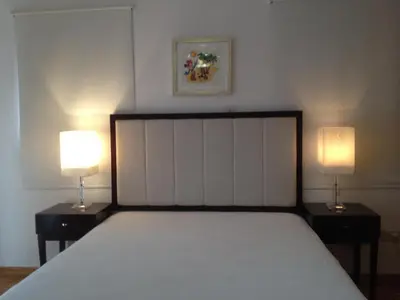 a bedroom with a bed and two lamps on tables at Lania Royal Oak House by TrulyCyprus in Lania
