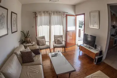 a living room with a couch and a tv at Lania Royal Oak House by TrulyCyprus in Lania