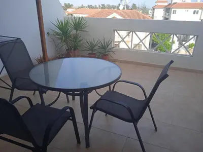 a glass table and two chairs on a balcony at Xylophagou Larnaca Ayia Napa 1 bedroom apartment in Xylophaghou