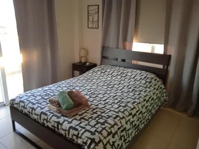 a bedroom with a bed with two towels on it at Xylophagou Larnaca Ayia Napa 1 bedroom apartment in Xylophaghou